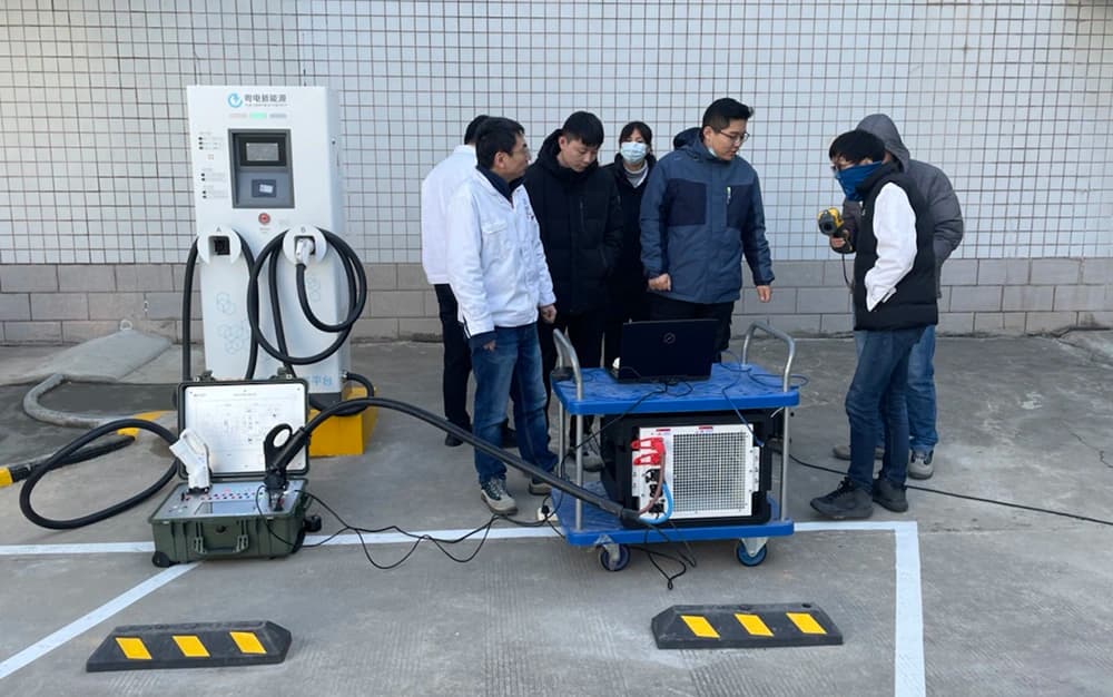 Portable charging test instrument and wheeled load unit connected to a DC charger