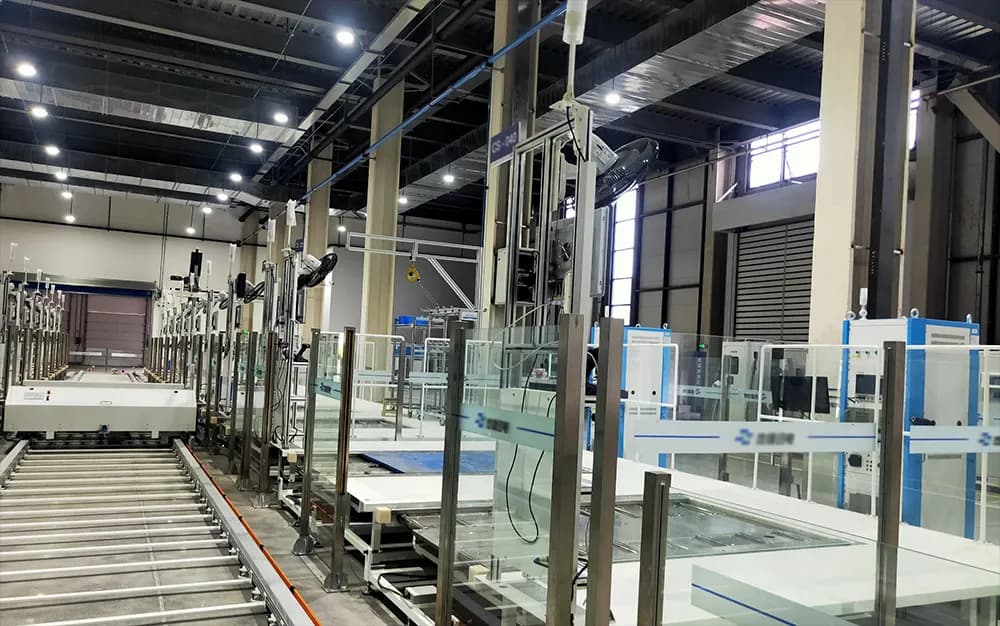 Automated test stations arranged along a roller conveyor in an industrial hall
